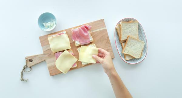 Farcire quattro fette di pane per toast con il formaggio cremoso. Aggiungere il crescione, i germogli o la lattuga. Affettare sottilmente il pomodoro e posizionare una fetta su ciascun toast.