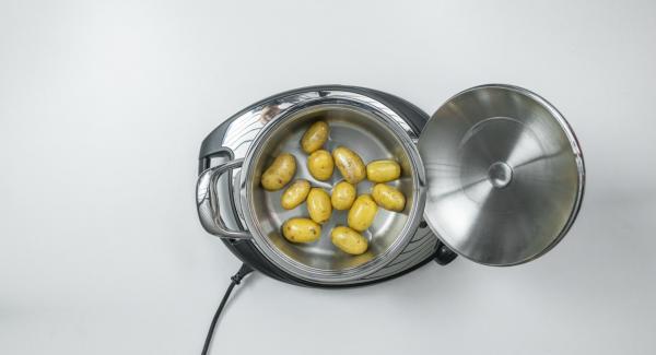 Posizionare le patate, ancora bagnate, all'interno di un'Unità di cottura 20 cm 2,3 l, coprirla con il coperchio e posizionarla su Navigenio impostato in modalità "A". Posizionare Audiotherm sulla finestra "verdura" dopo aver impostato un tempo di cottura di 8 minuti.