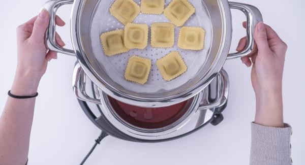 Adagiare all'interno dell'Unità di cottura l’acqua e la passata di pomodoro. Posizionare i ravioli su un disco di carta da forno e inserirlo nell’Inserto «2 in 1». Collocare l’Inserto «2 in 1» sopra l’Unità di cottura e coprire con EasyQuick.