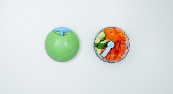 Per il misto di verdure, mondare i peperoni e le zucchine, tritare finemente nel Tritamix e metterli nell’Unità di cottura. Pelare la cipolla, tritarla finemente e distribuirla sulle verdure.