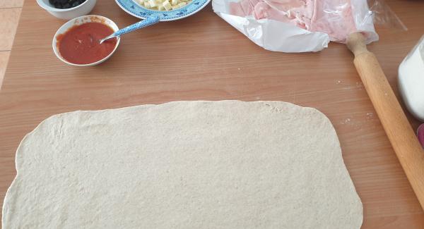 In un piano lavoro spolverizzato di farina con l'aiuto di un mattarello stendete l'impasto formando un rettangolo.